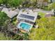 Aerial view of the home showcasing its private screened pool and solar panels at 413 Country Wood Cir, Lake Mary, FL 32746
