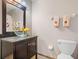 Bathroom featuring a vessel sink on a dark vanity with decorative towels and tile floor at 413 Country Wood Cir, Lake Mary, FL 32746