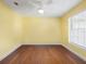 Sunny bedroom with hardwood floors, a ceiling fan, and a large window with blinds at 413 Country Wood Cir, Lake Mary, FL 32746