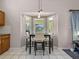 Bright dining area with modern light fixture and a bay window view of the pool at 413 Country Wood Cir, Lake Mary, FL 32746