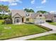 Charming home featuring a well-manicured lawn and attached two car garage at 413 Country Wood Cir, Lake Mary, FL 32746