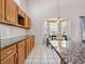Granite countertops and an eat-in dining area with large windows highlight this kitchen at 413 Country Wood Cir, Lake Mary, FL 32746