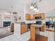 An open concept kitchen featuring wood cabinets, stainless steel appliances, and an island at 413 Country Wood Cir, Lake Mary, FL 32746