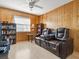 Living room boasting a comfortable leather recliner and wood paneling at 413 Country Wood Cir, Lake Mary, FL 32746
