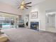 Spacious living room with a fireplace and sliding doors to the pool at 413 Country Wood Cir, Lake Mary, FL 32746