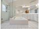 Spacious main bathroom featuring a soaking tub, separate shower, and white tile at 413 Country Wood Cir, Lake Mary, FL 32746