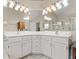 A double sink vanity with bright lighting in the spacious main bathroom at 413 Country Wood Cir, Lake Mary, FL 32746