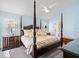 A main bedroom with a four-poster bed, ceiling fan, and ensuite bathroom access at 413 Country Wood Cir, Lake Mary, FL 32746
