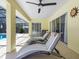 Covered patio seating area featuring chaise lounges and a ceiling fan at 413 Country Wood Cir, Lake Mary, FL 32746