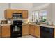 Well-equipped kitchen with granite countertops and modern appliances overlooking the living room at 4916 Cedarstone Lane, Orlando, FL 32822