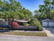 Aerial view of a home with a detached garage, surrounded by lush greenery at 500 E Crystal Lake St, Orlando, FL 32806