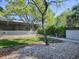Serene backyard with lush lawn, patio, stone landscaping, and mature trees, offering privacy and tranquility at 500 E Crystal Lake St, Orlando, FL 32806
