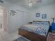 Bedroom featuring bed with stylish linens, ceiling fan, and closet with sliding doors, offering ample storage at 500 E Crystal Lake St, Orlando, FL 32806
