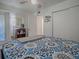 Bright bedroom boasts a bed, ceiling fan, and closet with sliding doors, complemented by a stylish bookcase at 500 E Crystal Lake St, Orlando, FL 32806