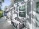 Exterior shot showing a well-maintained gray home with a bench, window, and two doors at 500 E Crystal Lake St, Orlando, FL 32806