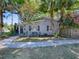Quaint home with a well-maintained lawn and mature trees, providing shade and curb appeal at 500 E Crystal Lake St, Orlando, FL 32806