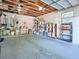 Spacious garage featuring exposed ceiling beams, block walls, shelving, and ample space for storage and projects at 500 E Crystal Lake St, Orlando, FL 32806