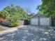 Detached two-car garage with ample parking space and lush landscaping, enhancing curb appeal at 500 E Crystal Lake St, Orlando, FL 32806