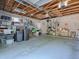 Garage featuring exposed ceiling beams, block walls, shelving, offering ample space for storage and parking at 500 E Crystal Lake St, Orlando, FL 32806