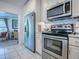 Well-equipped kitchen featuring stainless steel appliances and white cabinetry at 500 E Crystal Lake St, Orlando, FL 32806