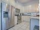 Modern kitchen featuring stainless steel appliances, white cabinets, and ample counter space at 500 E Crystal Lake St, Orlando, FL 32806