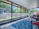Enclosed lanai with outdoor seating and a view of the lush backyard, providing a relaxing outdoor space at 500 E Crystal Lake St, Orlando, FL 32806