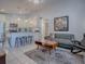 Open-concept living room seamlessly connected to a modern kitchen with bar stool seating at 500 E Crystal Lake St, Orlando, FL 32806