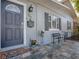Charming porch with slate tile, a decorative mailbox, and space for seating at 500 E Crystal Lake St, Orlando, FL 32806