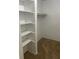 Walk-in closet features white shelving and carpeted floor at 5317 Curry Ford Rd # Q104, Orlando, FL 32812