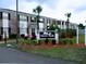 Grove Park condominium property sign surrounded by colorful plants at 5317 Curry Ford Rd # Q104, Orlando, FL 32812