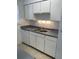 Functional kitchen design with white cabinets, countertops, and a sink at 5317 Curry Ford Rd # Q104, Orlando, FL 32812