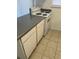 This cozy kitchen features a white stove with matching countertops and cabinets at 5317 Curry Ford Rd # Q104, Orlando, FL 32812
