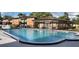 Community pool with clear blue water surrounded by brick buildings at 5317 Curry Ford Rd # Q104, Orlando, FL 32812