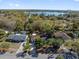 Aerial view of a neighborhood featuring well-kept houses near a picturesque lake, surrounded by lush trees at 5325 Glasgow Ave, Orlando, FL 32819