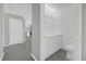 Bright bathroom with updated vanity, white cabinets, and gray wood floors at 5325 Glasgow Ave, Orlando, FL 32819