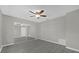 A spacious bedroom with modern flooring, mirrored closet and a stylish ceiling fan at 5325 Glasgow Ave, Orlando, FL 32819