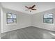 This bright bedroom features two windows, modern flooring and natural light at 5325 Glasgow Ave, Orlando, FL 32819