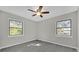 A naturally lit bedroom featuring modern flooring and two windows at 5325 Glasgow Ave, Orlando, FL 32819