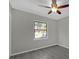 Bedroom showcasing a window, modern flooring and a ceiling fan at 5325 Glasgow Ave, Orlando, FL 32819