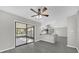 Open dining room features gray wood floors, a ceiling fan, and sliding glass doors to a screened-in porch at 5325 Glasgow Ave, Orlando, FL 32819