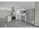 Bright kitchen featuring stainless steel appliances, granite countertops, and gray wood floors at 5325 Glasgow Ave, Orlando, FL 32819
