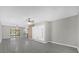 Bright, neutral living room with a ceiling fan and sliding glass doors to the outside at 5325 Glasgow Ave, Orlando, FL 32819