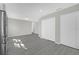 Neutral living room with two large closets and gray wood floors at 5325 Glasgow Ave, Orlando, FL 32819