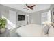 Bright main bedroom with a ceiling fan and an ensuite bathroom at 5325 Glasgow Ave, Orlando, FL 32819