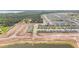Discover this aerial view showcasing a growing neighborhood and the potential for community living by the lake at 5996 Wildflower Field Way, St Cloud, FL 34771