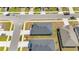 A neatly designed residential layout with well-maintained streets, a green yard and a dark gray shingle roof at 5996 Wildflower Field Way, St Cloud, FL 34771
