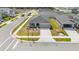 New construction home featuring a two-car garage, a cozy front porch, and a well-maintained lawn at 5996 Wildflower Field Way, St Cloud, FL 34771