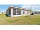 View of the backyard featuring a screened in porch and a partial view of the exterior at 5996 Wildflower Field Way, St Cloud, FL 34771