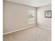 An empty bedroom featuring neutral walls and carpet with a window view at 5996 Wildflower Field Way, St Cloud, FL 34771