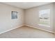 Cozy bedroom featuring neutral walls, carpeted floors, and a window at 5996 Wildflower Field Way, St Cloud, FL 34771